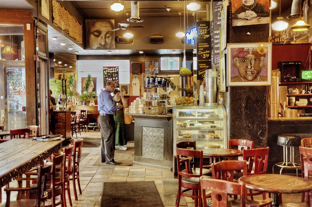 Eclectic coffee shop with art all over the walls and a small bakery