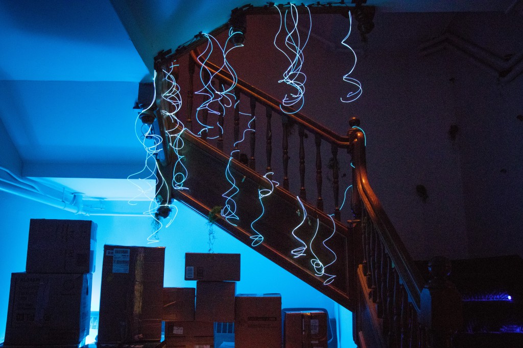glowing wires hang over a staircase and a series of boxes
