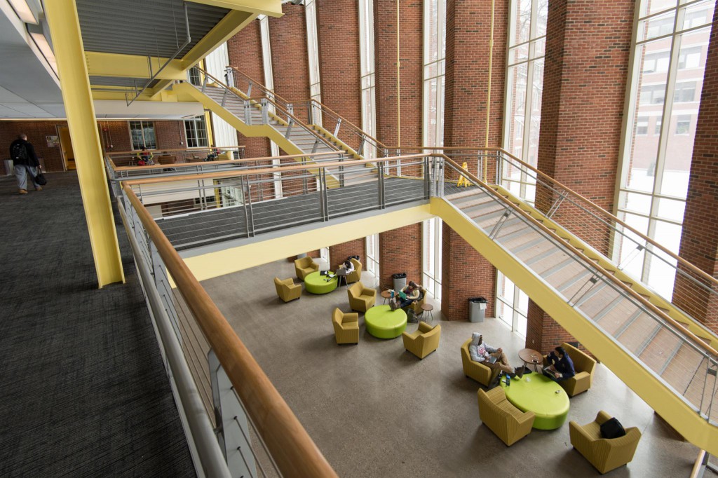 Rettner Hall, a futuristic space with open staircases and brick and yellow metal accents