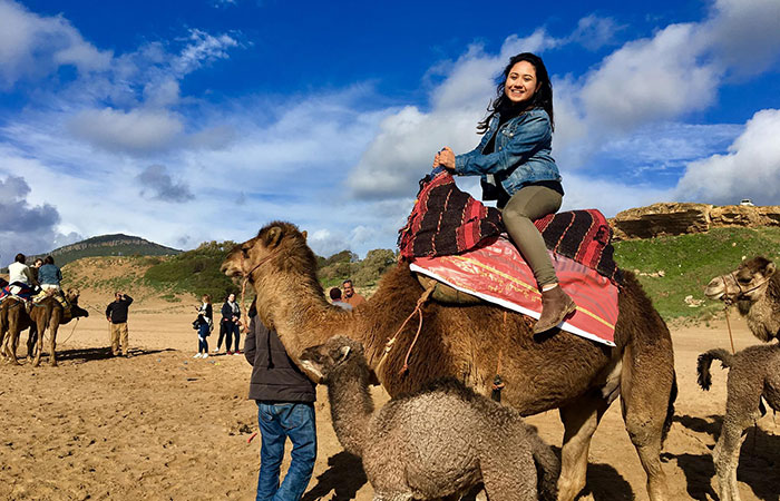 Student Gina Bolanos riding a camel in Madrid, Spain