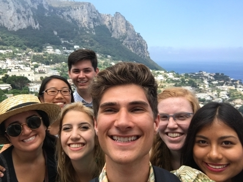 Student John Cole in a selfie in front of the city of Procida, Italy