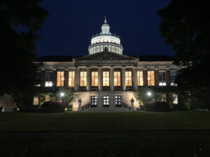 A photo of Rush Rhees Library at night.