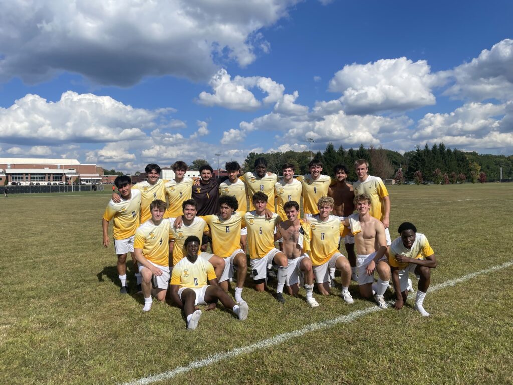 Students playing soccer together during a club practice at the University of Rochester.