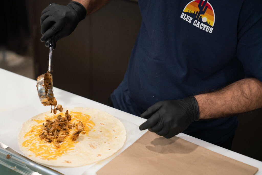 Dining staff prepare food behind the counter at Blue Cactus at the University of Rochester.