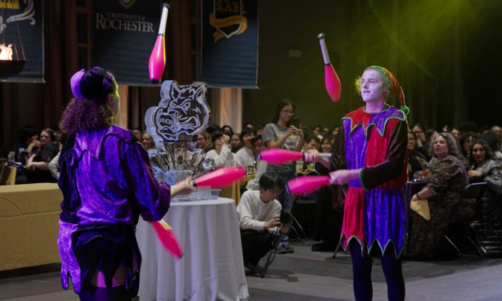 Students juggle at the Boar's Head Dinner.