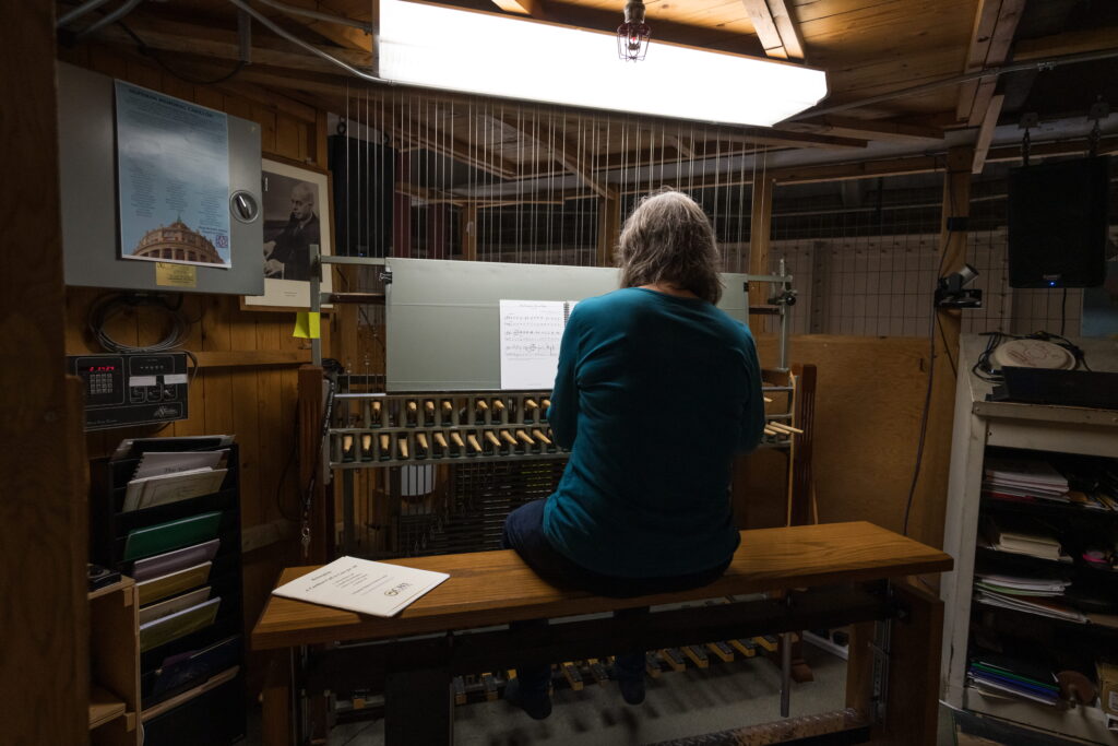 An individual playing the Carillon in Rush Rhees Library.