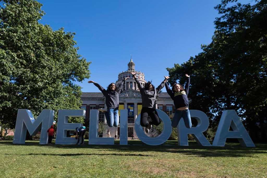 UR students jump in front of the Meliora letters on Eastman Quad during University of Rochester’s Meliora Weekend.