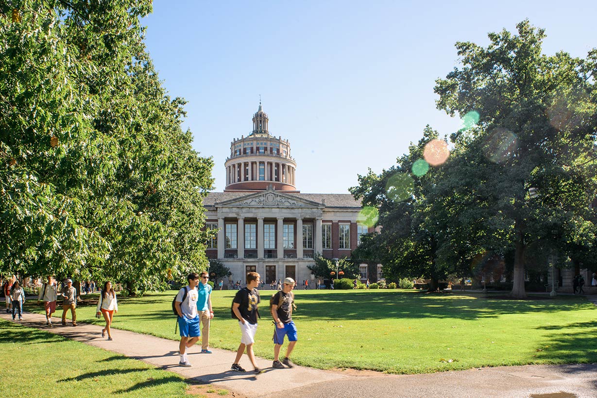 Students walking across the quad on a summer day.