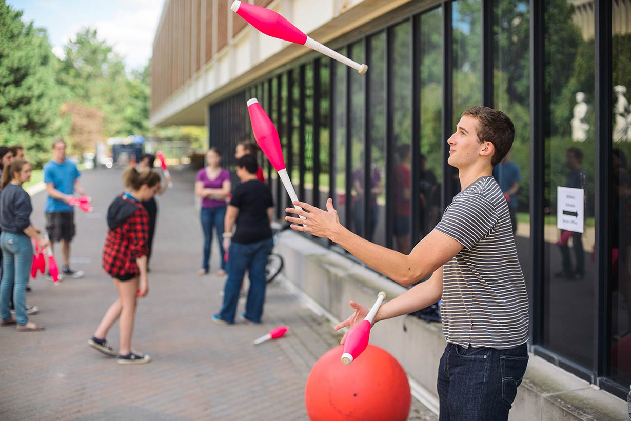 A student practicing juggling.