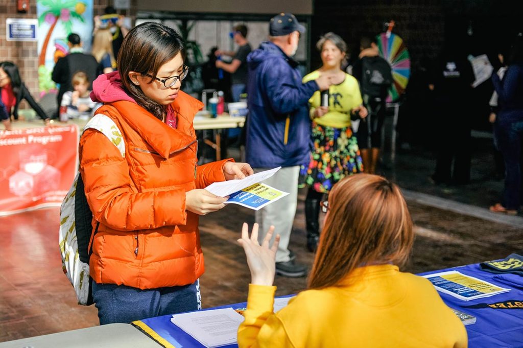 A prospective student talking with a counselor.