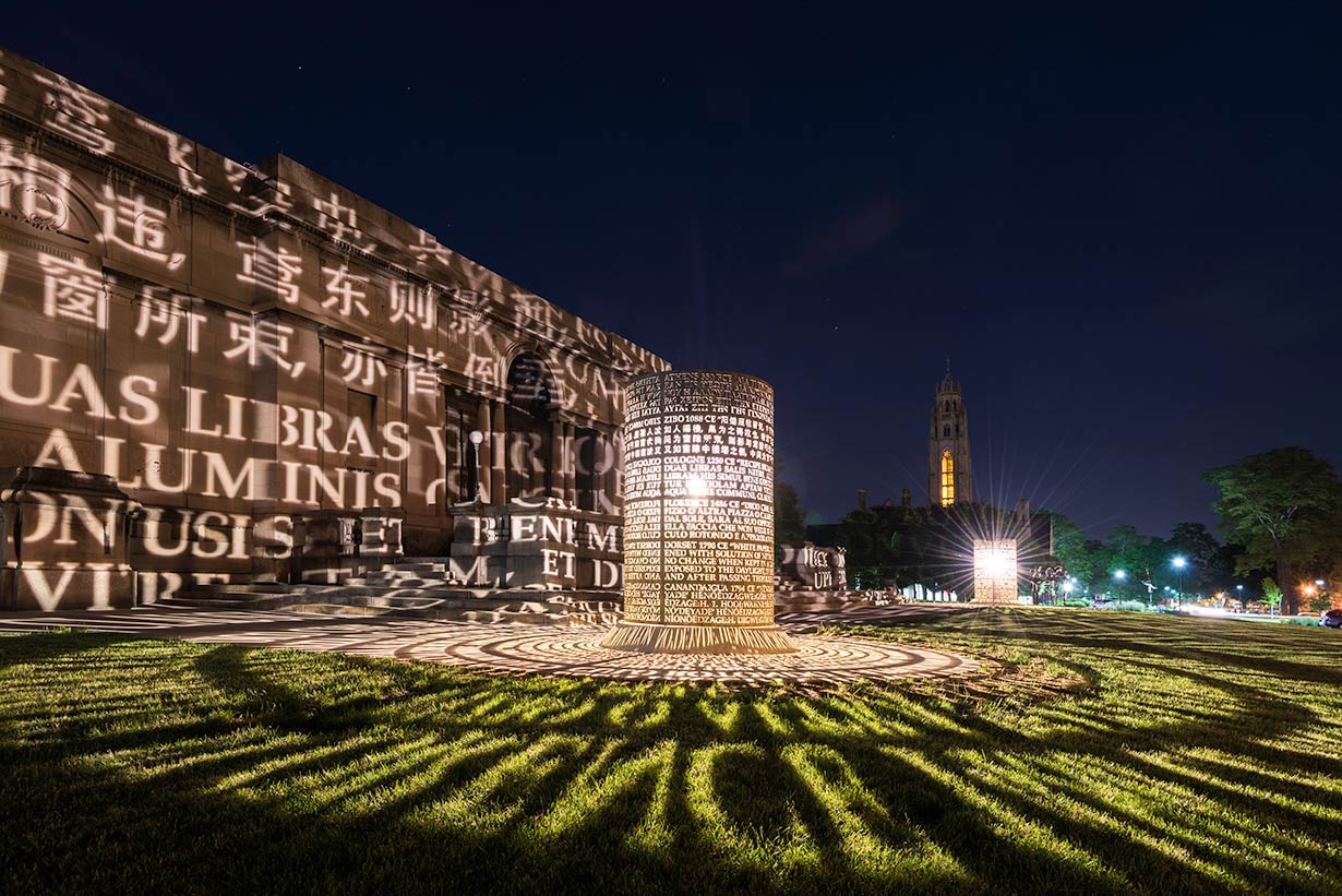 An illuminated art installation at night outside the Memorial Art Gallery.