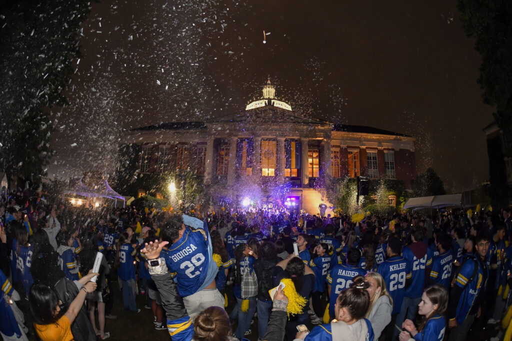 Hundreds of University of Rochester class of 2029 attend a jersey giveaway and Candlelight Ceremony after signing the class roll on Eastman Quad.