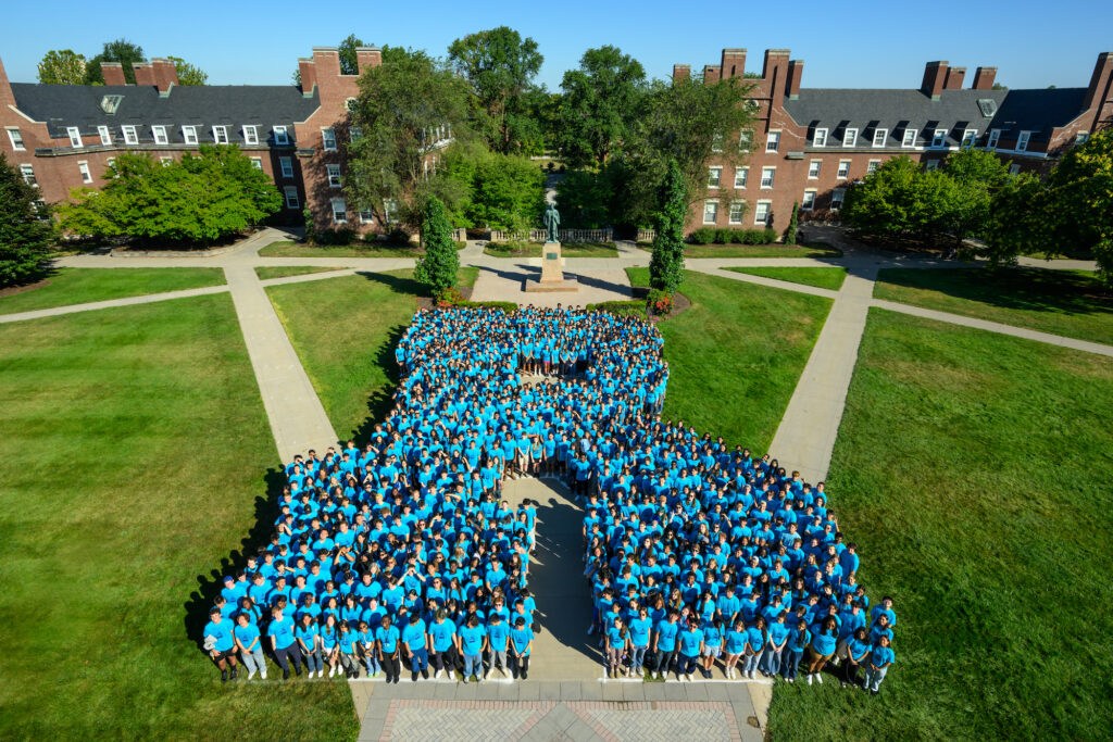 Students of the URochester class of 2029 pose for a photo on Wilson Quad in an "R" formation.