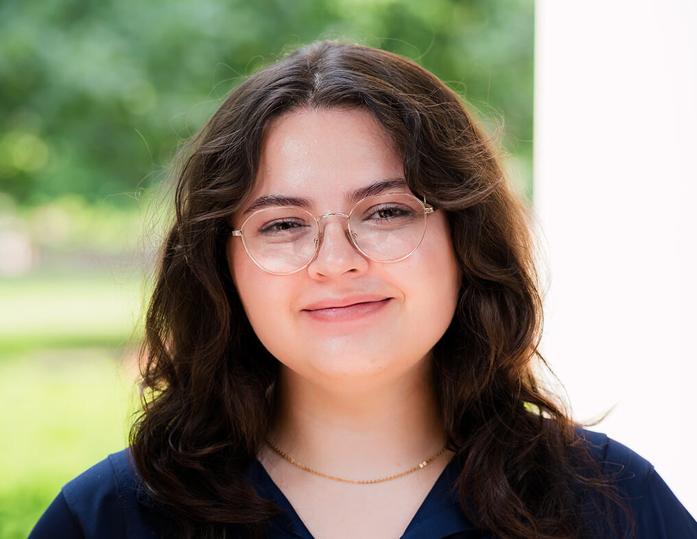 A URochester student stands for a photo on campus.