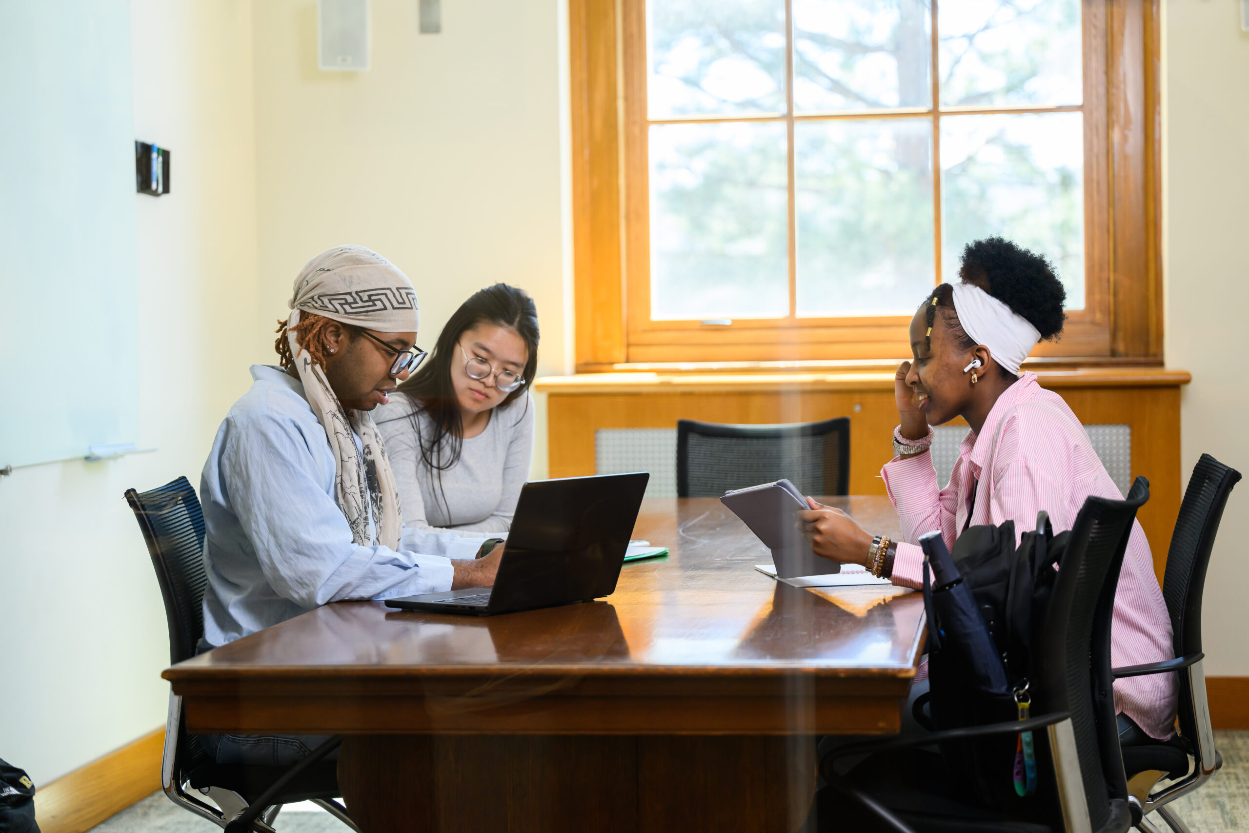 Three students meet and work in the Humanities Center at Rush Rhees Library.