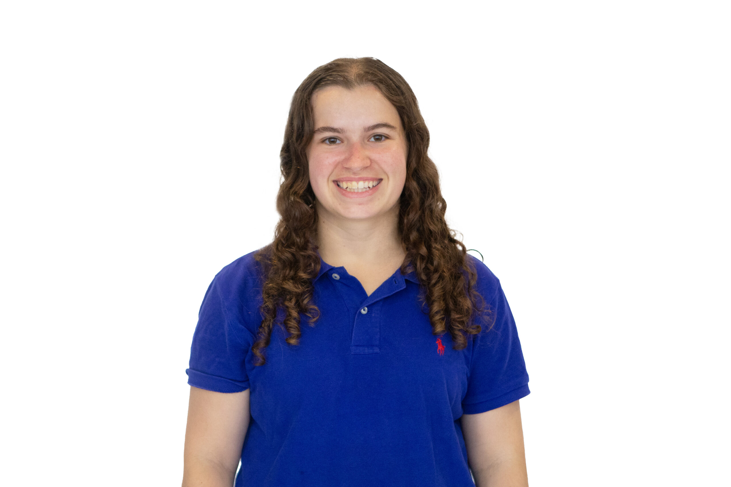 Sarah Kideckel '27 wears a blue polo shirt in front of a white backdrop.